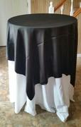 Bistro table with white tablecloth and black overlay Bistro table with white tablecloth and black overlay